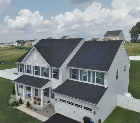 Home with rooftop solar panels, seen from the corner