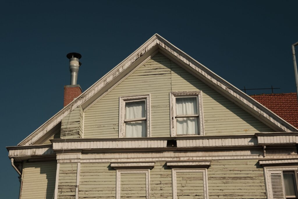 Older home with weathered siding and trim